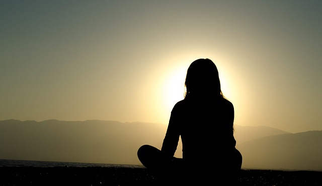 Women practicing presence and enjoying a sunrise