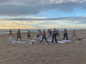 View of yoga class following their yoga instructor's pose