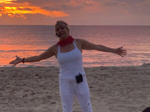 View of yoga instructor with out stretched hands