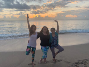 Three women doing yoga poses together