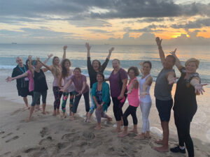 View of yoga class posing together