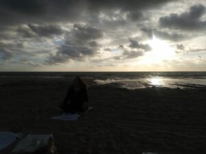 View of yoga class as the sun goes down