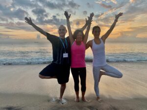 Three yoga students posing together