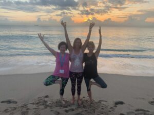 Three yoga friends posing together