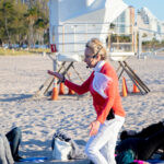 View of yoga teacher instructing her students