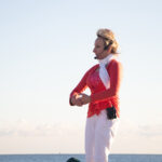 View of woman teaching a yoga class.