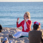 View of yoga instructor on the beach