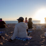 View of students stretching on the beach