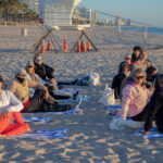 View of yoga class stretching